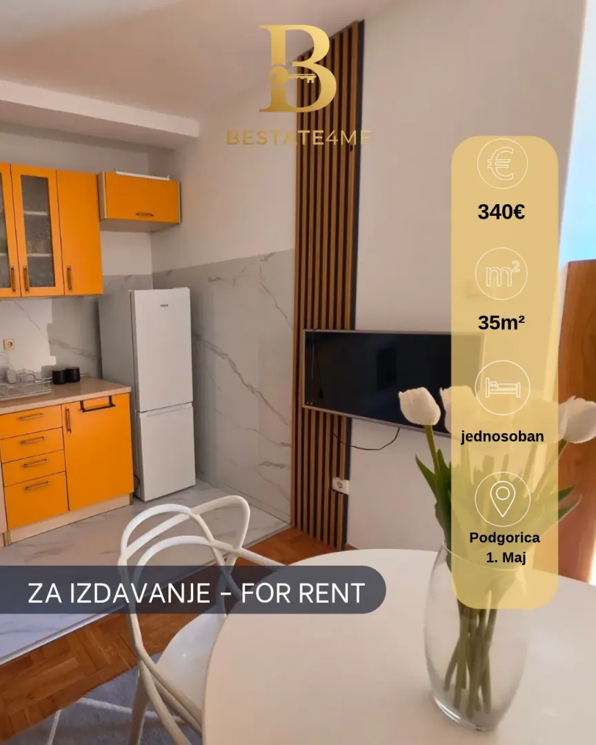 Small kitchen with orange cabinets and a dining table.