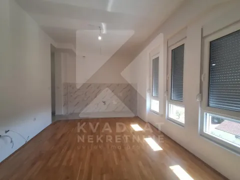 Empty room with hardwood floors and a designated space for a kitchen. - image 6