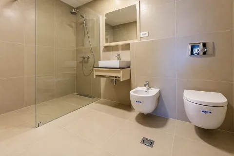 Modern bathroom with walk-in shower, washbasin, and wall-hung toilet with bidet. - image 9
