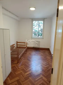 Smaller bedroom with a wooden bed and a wardrobe. - image 14
