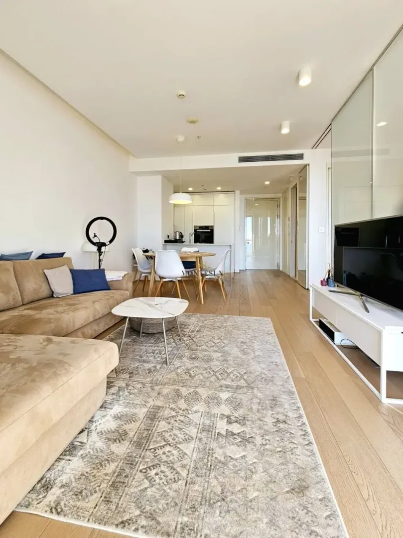 Spacious bright living room connected with the dining area and kitchen.