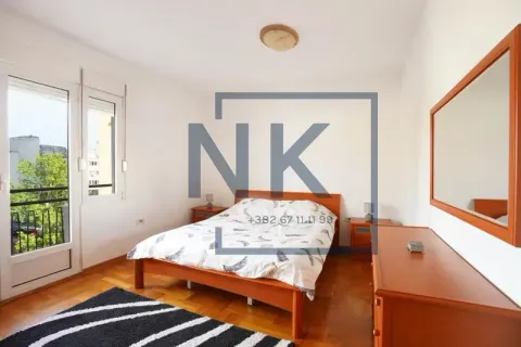 Bedroom with a double bed, wooden furniture, and access to a terrace. - image 5
