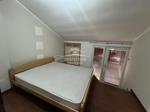 Attic bedroom with a double bed and sloped ceiling. - image 16