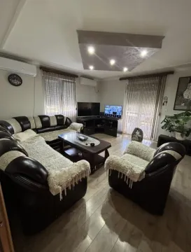 Spacious living room with seating set and TV. - image 2