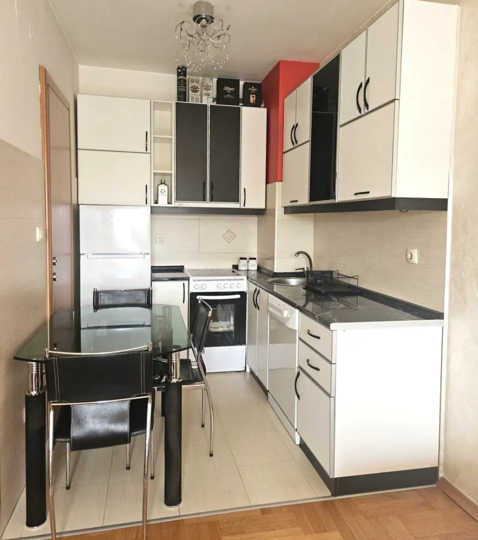 Small kitchen with a dining table and chairs.