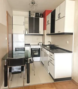 Small kitchen with a dining table and chairs. - image 2