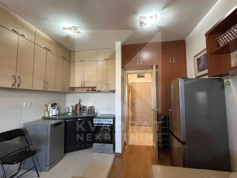 Kitchen equipped with wooden cabinets and home appliances. - image 4