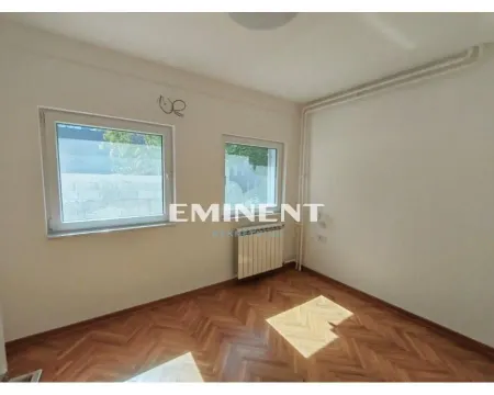Empty room with parquet flooring and two windows. - image 5