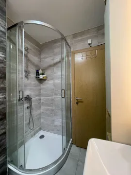 Bathroom with a shower cabin and a sink. - image 6