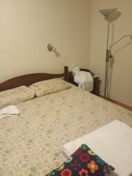 A bedroom with a double bed and a lamp. - image 9
