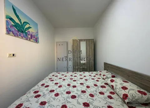 Furnished bedroom with a double bed, wardrobe, and a painting on the wall. - image 3