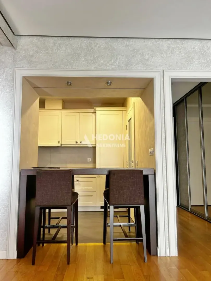Compact kitchen with a breakfast bar and bar stools.