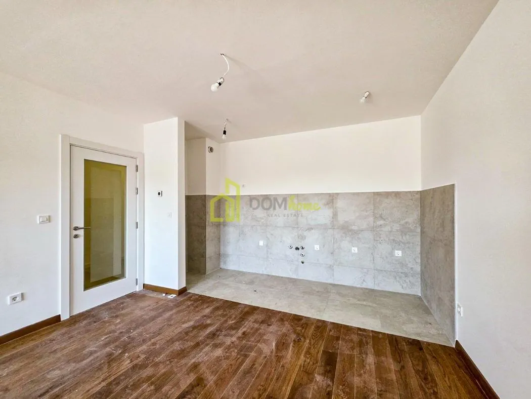 Unfurnished kitchen area with ceramic tiles on the wall and floor.