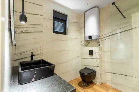 Moderno kupatilo sa crnim umivaonikom i bojlerom. - image 11