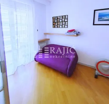 Living room with a purple armchair and laminate flooring. - image 5