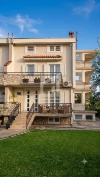 View of the exterior of the building with a landscaped yard and terraces. - image 7