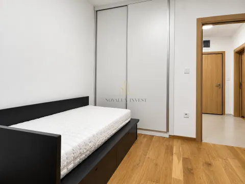 Smaller bedroom with a bed and a built-in wardrobe. - image 11