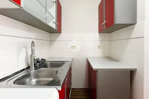 Smaller kitchen with a sink and fitted cabinets. - image 9