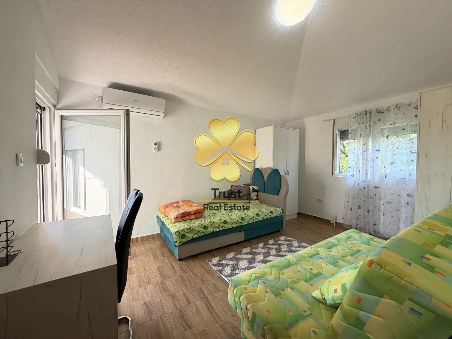 Children's bedroom with beds, a desk, and access to the terrace.