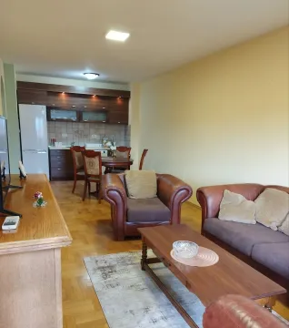 Living room with leather furniture and kitchen. - image 3