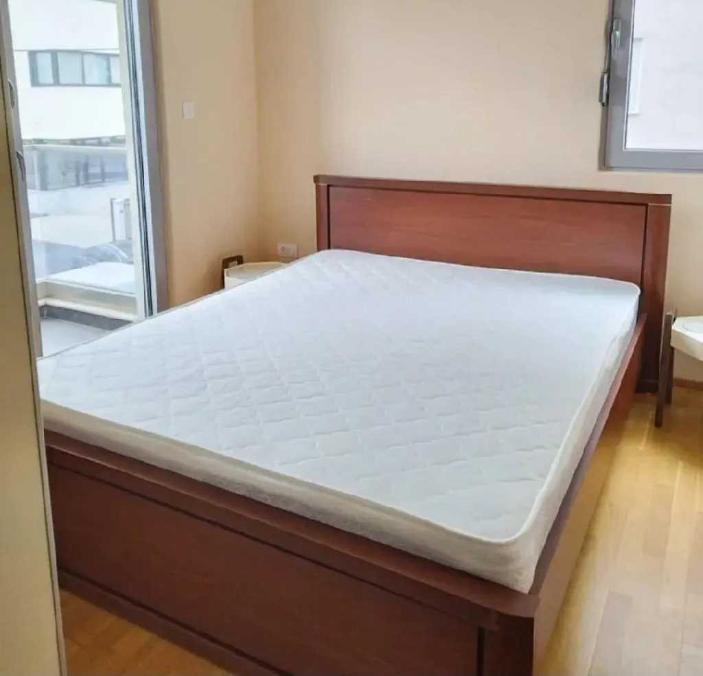 Bedroom with a double bed and parquet flooring.