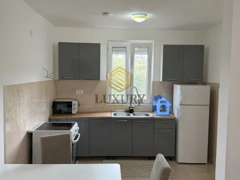 Kitchen equipped with grey cabinets and basic household appliances. - image 6
