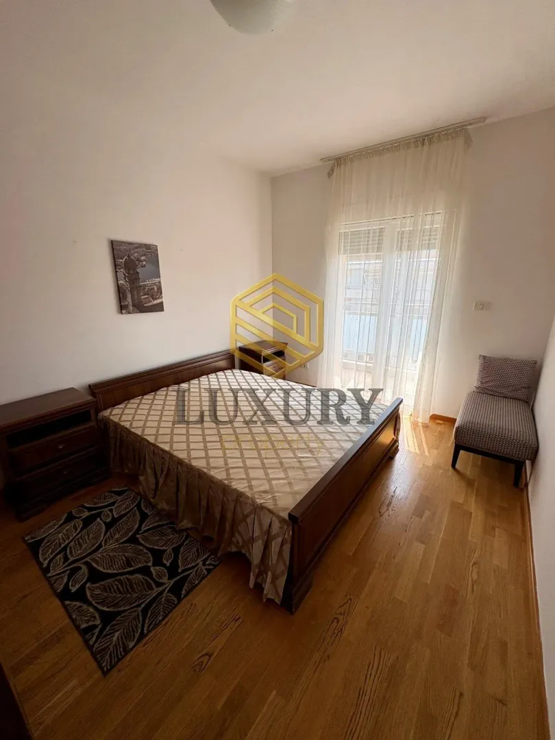 Bedroom with a double bed, bedside tables, and balcony access.