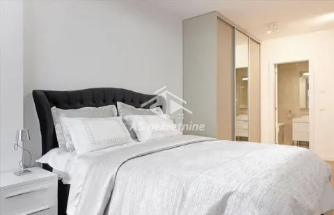 Bedroom with a double bed, wardrobe, and an en-suite bathroom. - image 12