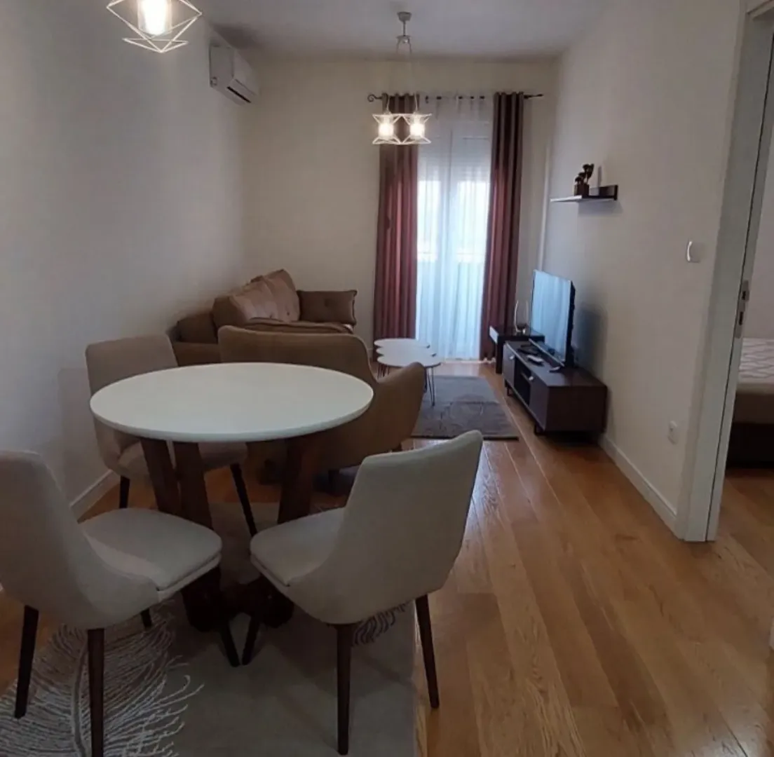 Living room with a dining table and sofa set.