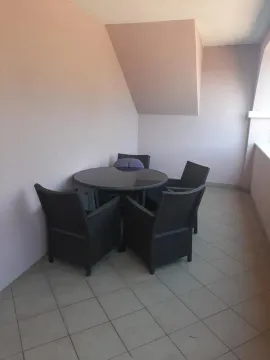 Covered terrace with seating furniture and a table. - image 22