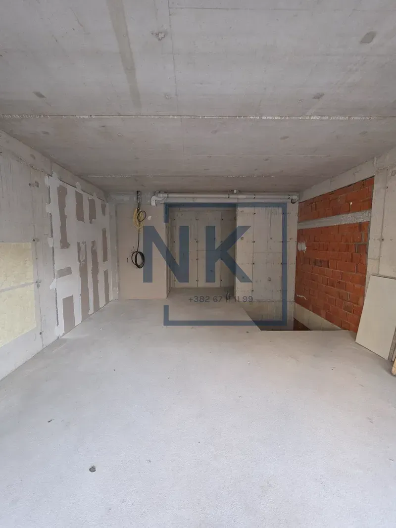 Unfinished space under construction with concrete floors and walls.