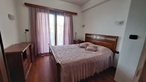 Spavaća soba sa bračnim krevetom, drvenim namještajem i zavjesama. - image 11