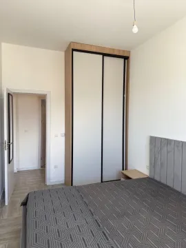 Furnished bedroom with a double bed and a built-in wardrobe. - image 2
