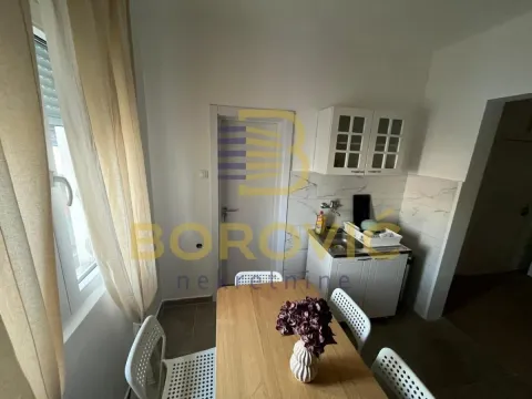 Small kitchen with a dining table and a window. - image 5