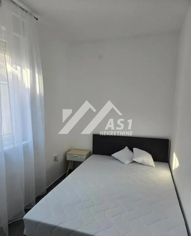 Bedroom with a double bed and a nightstand.