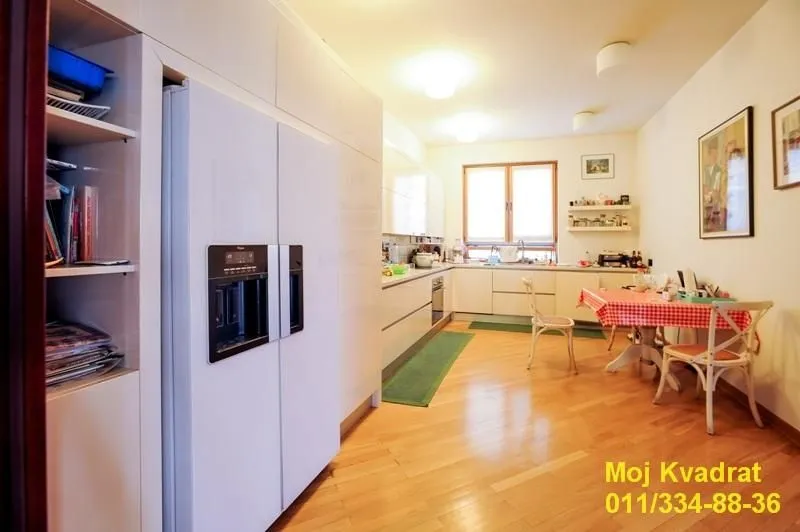 Spacious kitchen with a dining table and built-in refrigerator.