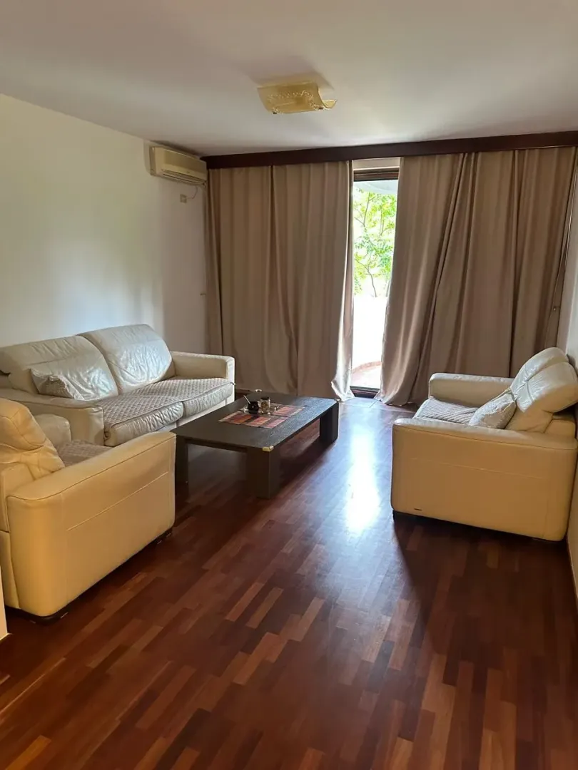 Living room with seating furniture and wooden flooring.