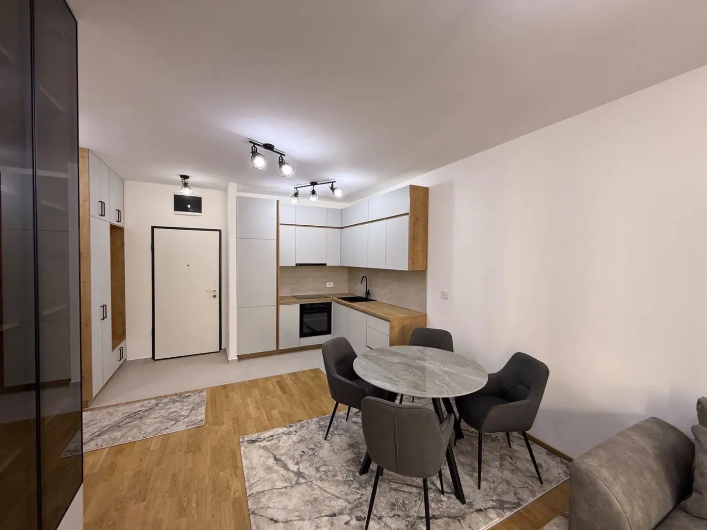 Modern kitchen with a dining table and chairs in an open space layout.