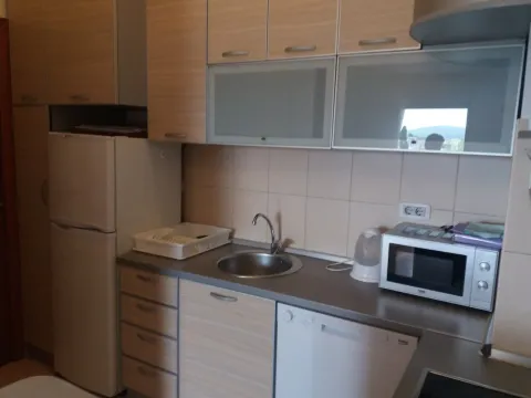Simple kitchen with light cabinets and appliances. - image 4