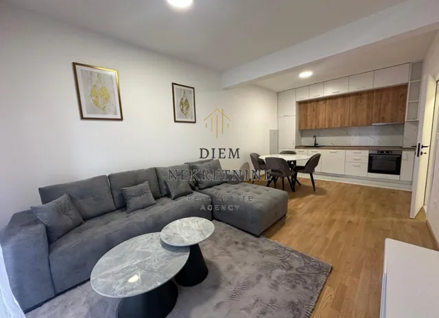 Modern living room connected to the dining area and kitchen.