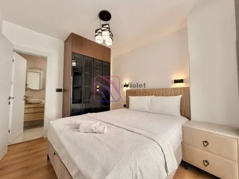 Furnished bedroom with a double bed, wardrobe, and a view of the bathroom. - image 6