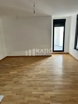 Empty room with hardwood floors and white walls. - image 6