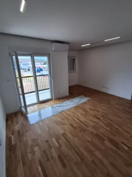 Empty room with wooden flooring, air conditioning unit, and access to the terrace. - image 12