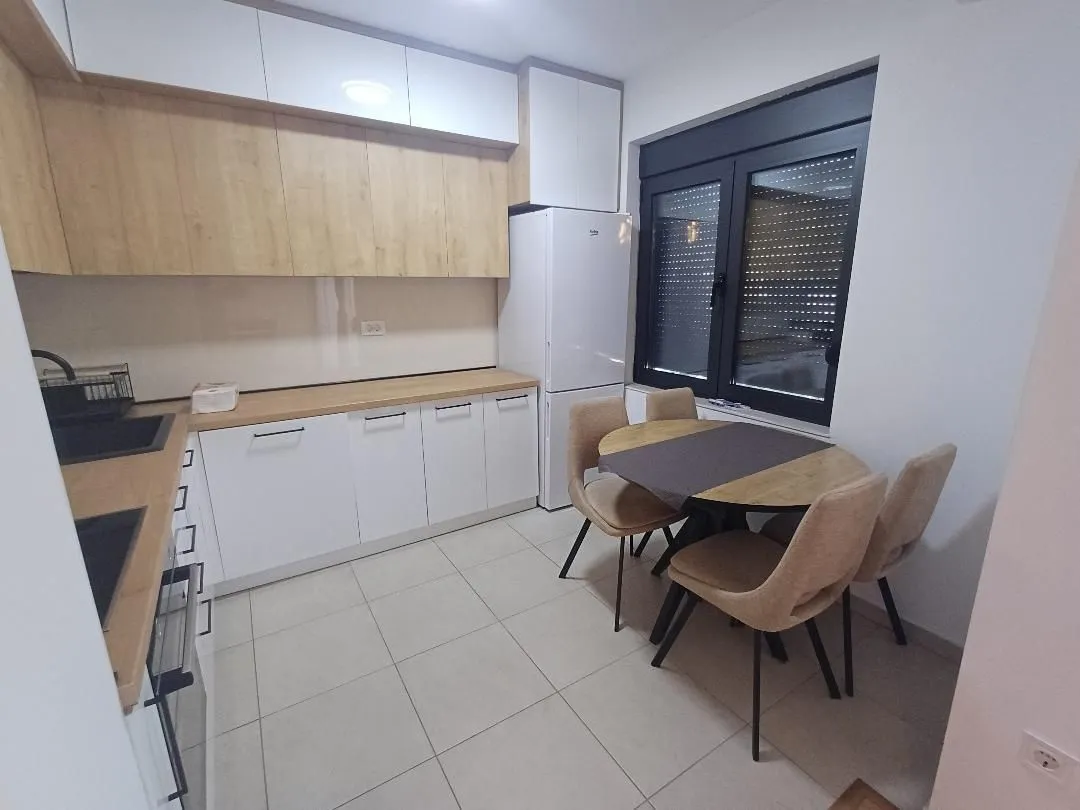 Modern kitchen with a dining table and chairs.