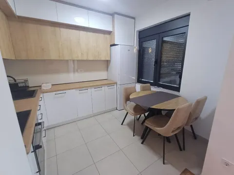 Modern kitchen with a dining table and chairs. - image 4