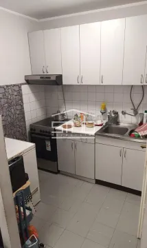 Small kitchen with white cabinets, stove, and sink. - image 4