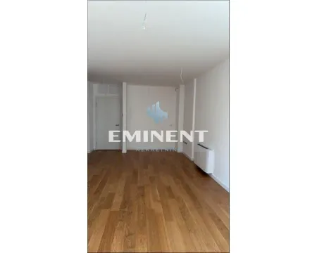 An empty room with wooden flooring and white walls. - image 7