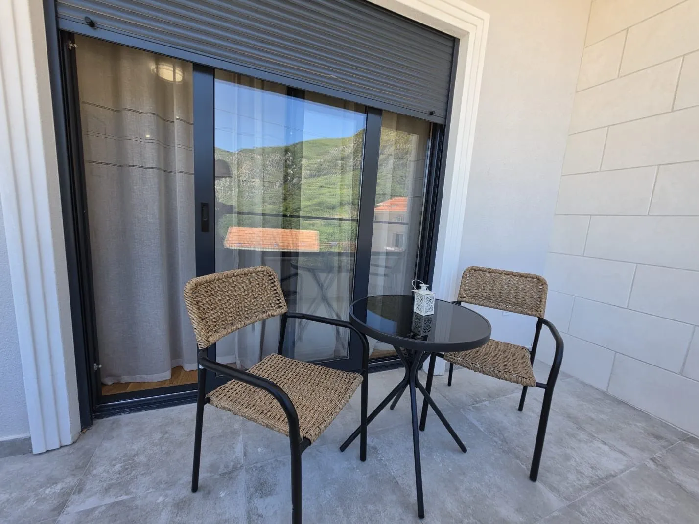 Furnished terrace with a table and two chairs.