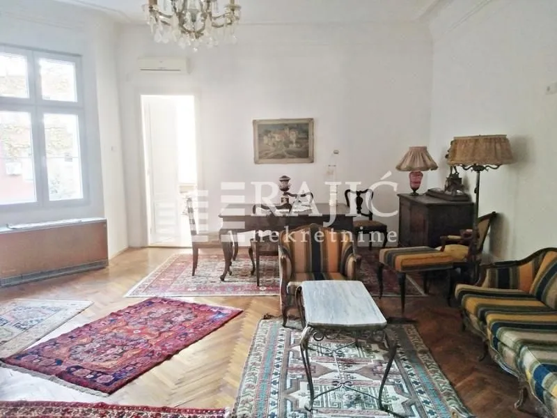 Spacious living room with seating area and dining table.