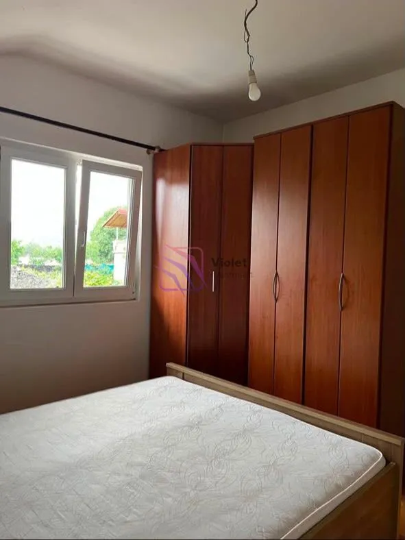 Bedroom with a double bed and wooden wardrobe.
